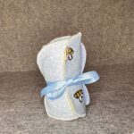 Pack of handmade makeup remover pads in baby blue bee print with lavender microfiber backing tied with light blue ribbon
