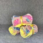 Two packs of handmade makeup remover pads in pink butterfly print with yellow microfiber backing tied with yellow ribbon