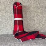 Muss Busters reusable towel in red and black buffalo check print with roll standing