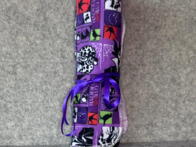 Muss Busters reusable towel roll in Disney Villains print tied with purple ribbon
