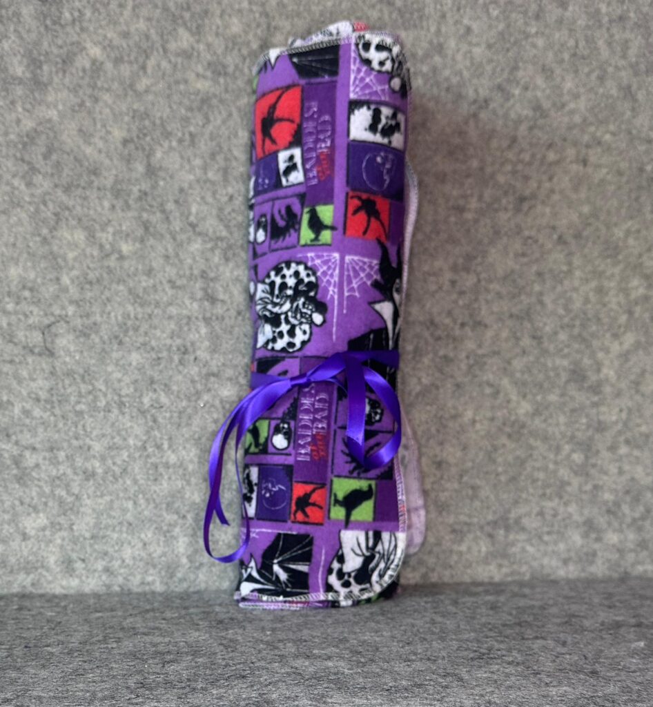 Muss Busters reusable towel roll in Disney Villains print tied with purple ribbon