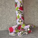 Muss Busters reusable towel in lavender frog and strawberry print with towel draped beside roll