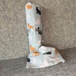 Muss Busters reusable towel in light blue cat print with roll standing and towel draped