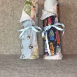 Two Muss Busters mixed print reusable towel rolls - Nature mix with bees and florals, Cats mix with lava lamp cats, both with light blue ribbons