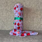 Muss Busters reusable towel in periwinkle strawberry print with towel draped beside roll