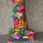 Muss Busters reusable towel roll and loose towel in colorful psychedelic dinosaur print with silver ribbon